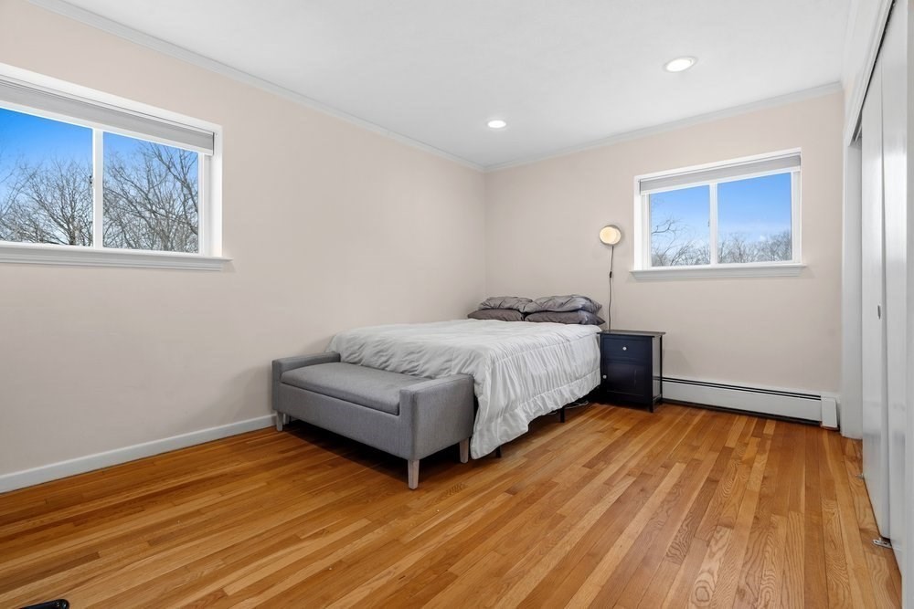 135 Granite Avenue, Unit 49 Boston, MA 02124 - Photo 7 of 14 a bedroom with a bed and a wall painting