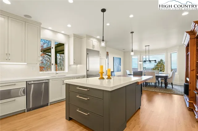 a kitchen with a sink stove and table