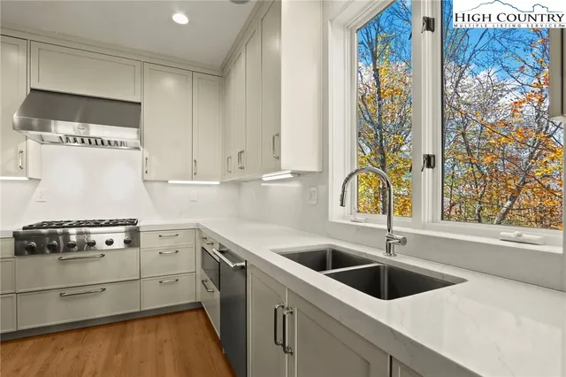 a kitchen with a sink a stove and cabinets