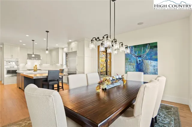 a view of a dining room with furniture wooden floor and chandelier
