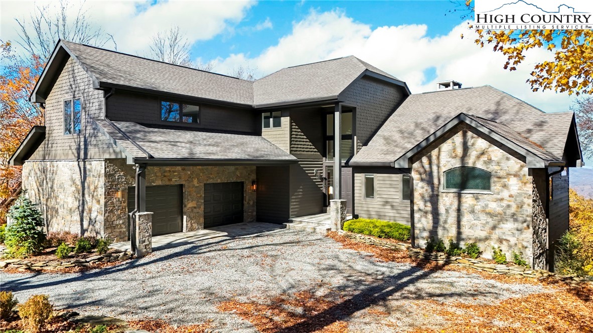 110 Pinnacle Ridge Road Beech Mountain, NC 28604 - Photo 2 of 49 a view of a house with large windows and a small yard