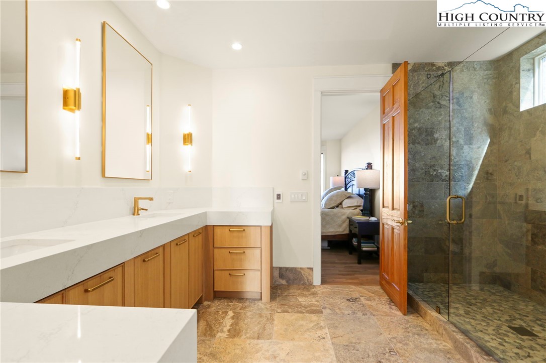 110 Pinnacle Ridge Road Beech Mountain, NC 28604 - Photo 21 of 49 a bathroom with a tub a mirror and a shower