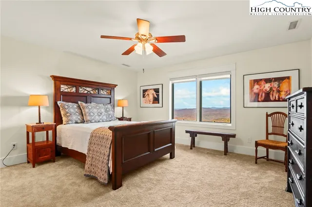 a bed room with a bed and a chair