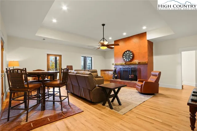 a living room with furniture a dining table and a fireplace