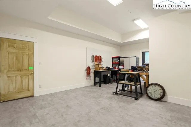 a view of a livingroom with workspace and a window