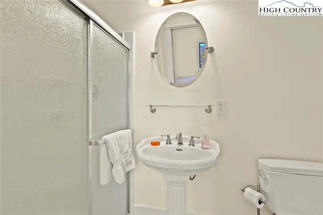 a bathroom with a sink a mirror and a toilet