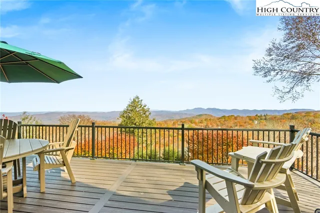 a view of a balcony with wooden floor and outdoor seating