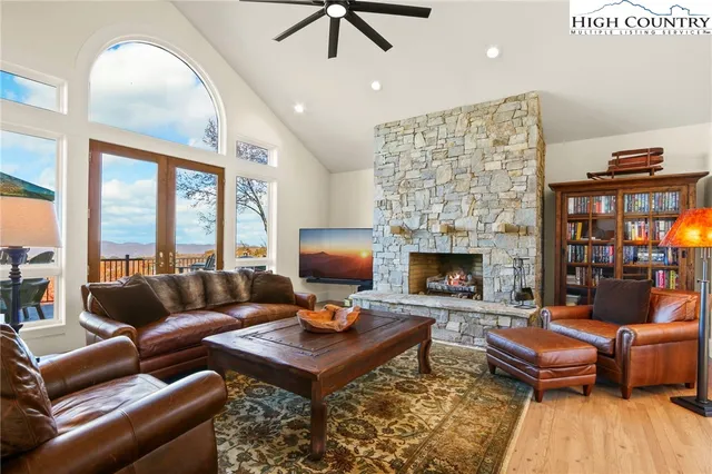 a living room with furniture a fireplace and a table