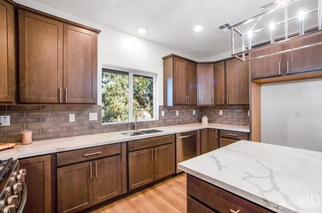 a kitchen with a sink cabinets and window