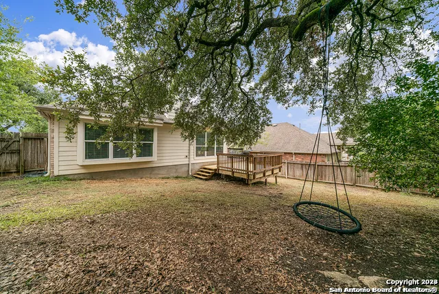 a view of house with wooden floor and fence