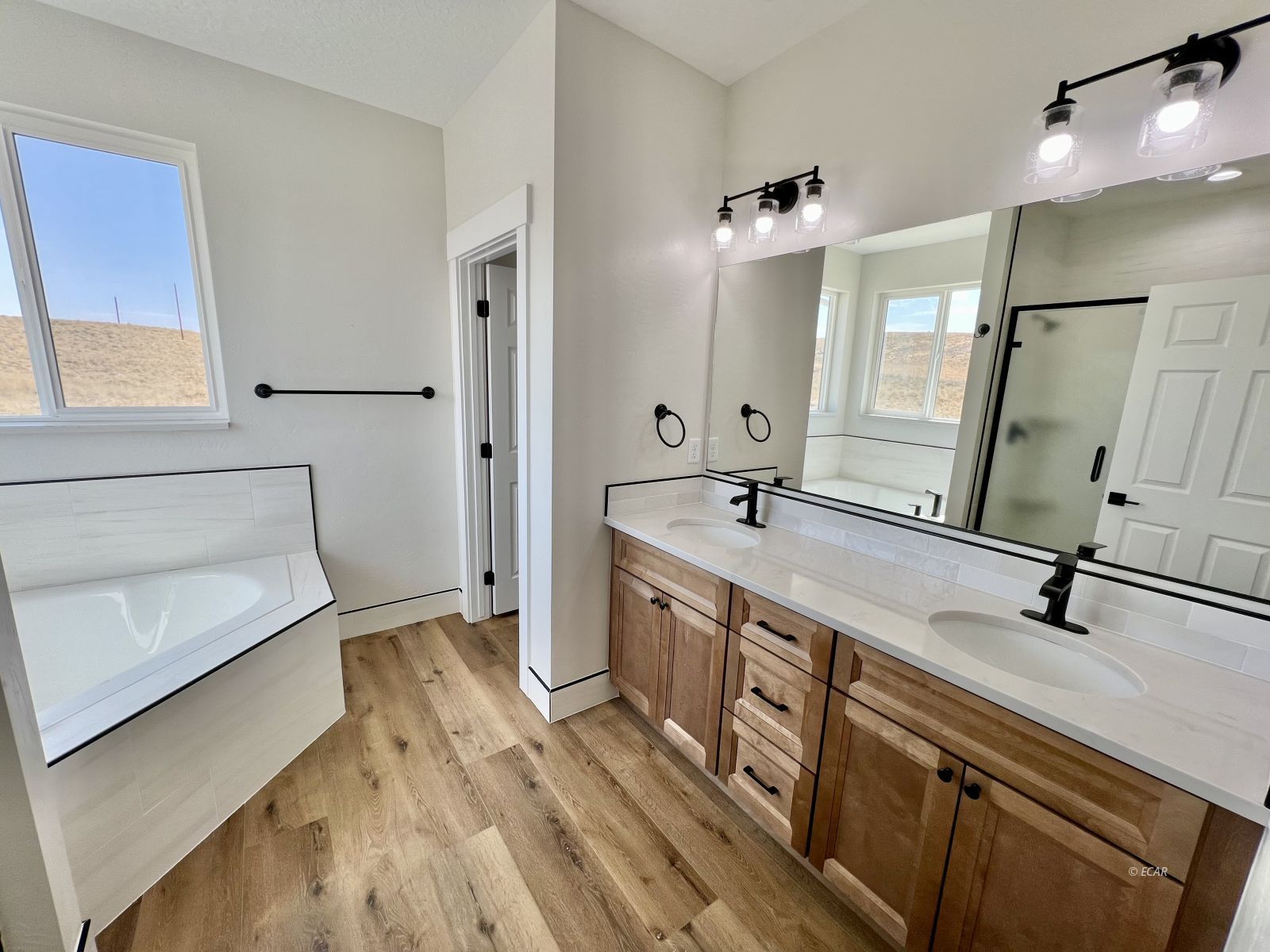 610 Ridgeway Drive Spring Creek, NV 89815 - Photo 23 of 33 a bathroom with a double vanity sink a mirror and a shower