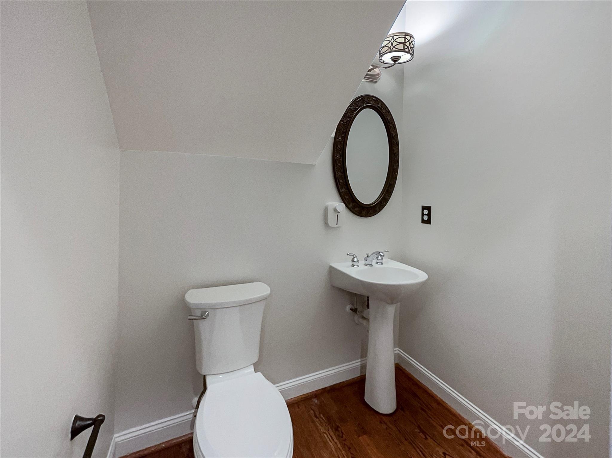 604 Panthers Way Fort Mill, SC 29708 - Photo 18 of 24 a bathroom with a toilet a sink and a mirror