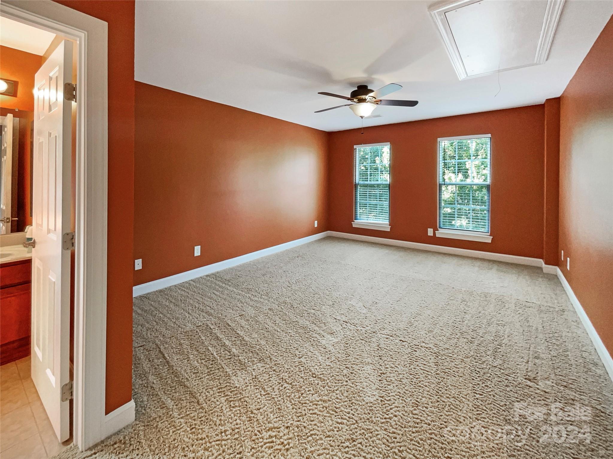 604 Panthers Way Fort Mill, SC 29708 - Photo 23 of 24 an empty room with windows and ceiling fan
