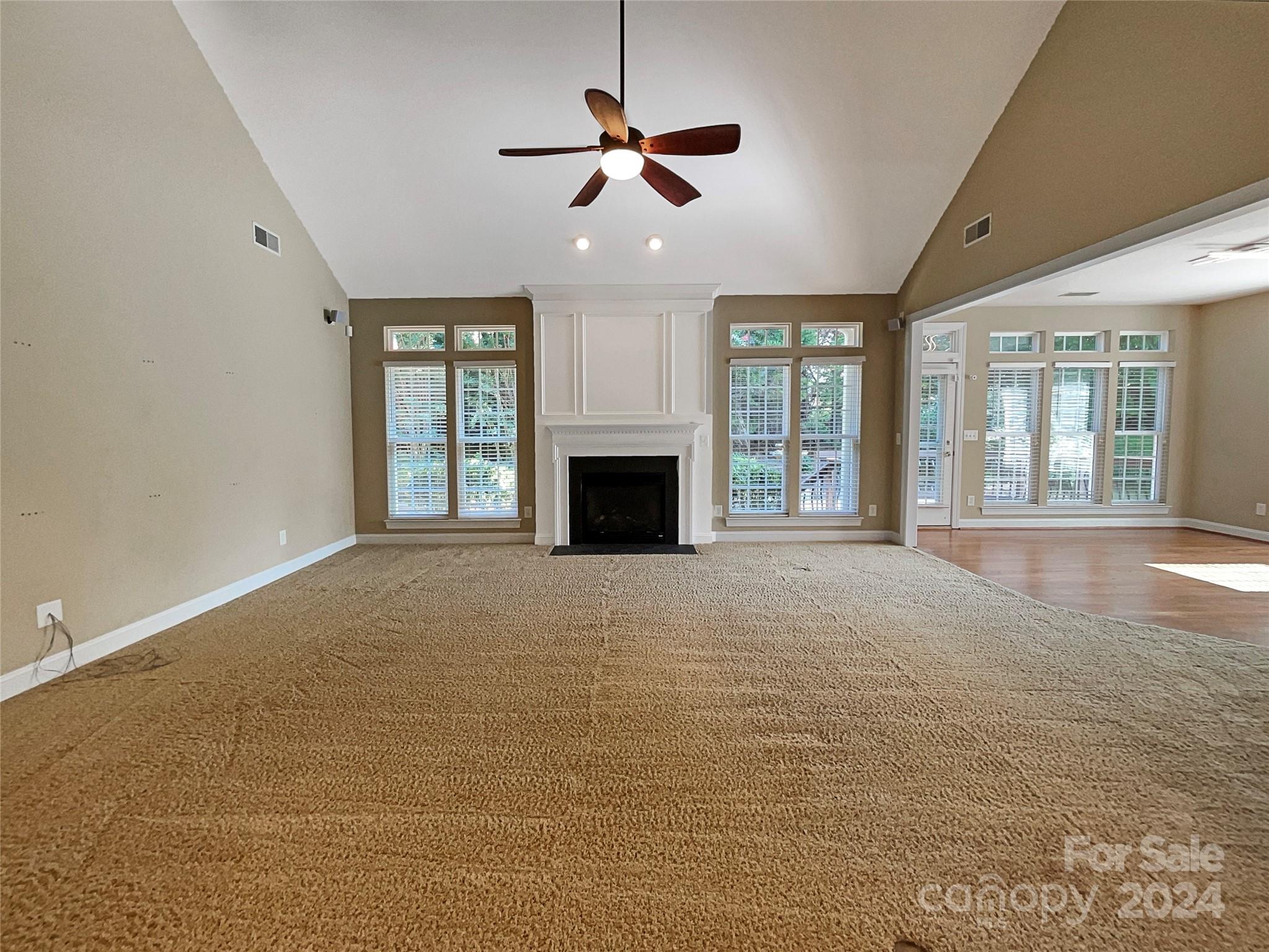 604 Panthers Way Fort Mill, SC 29708 - Photo 3 of 24 a view of an empty room with a fireplace and a window