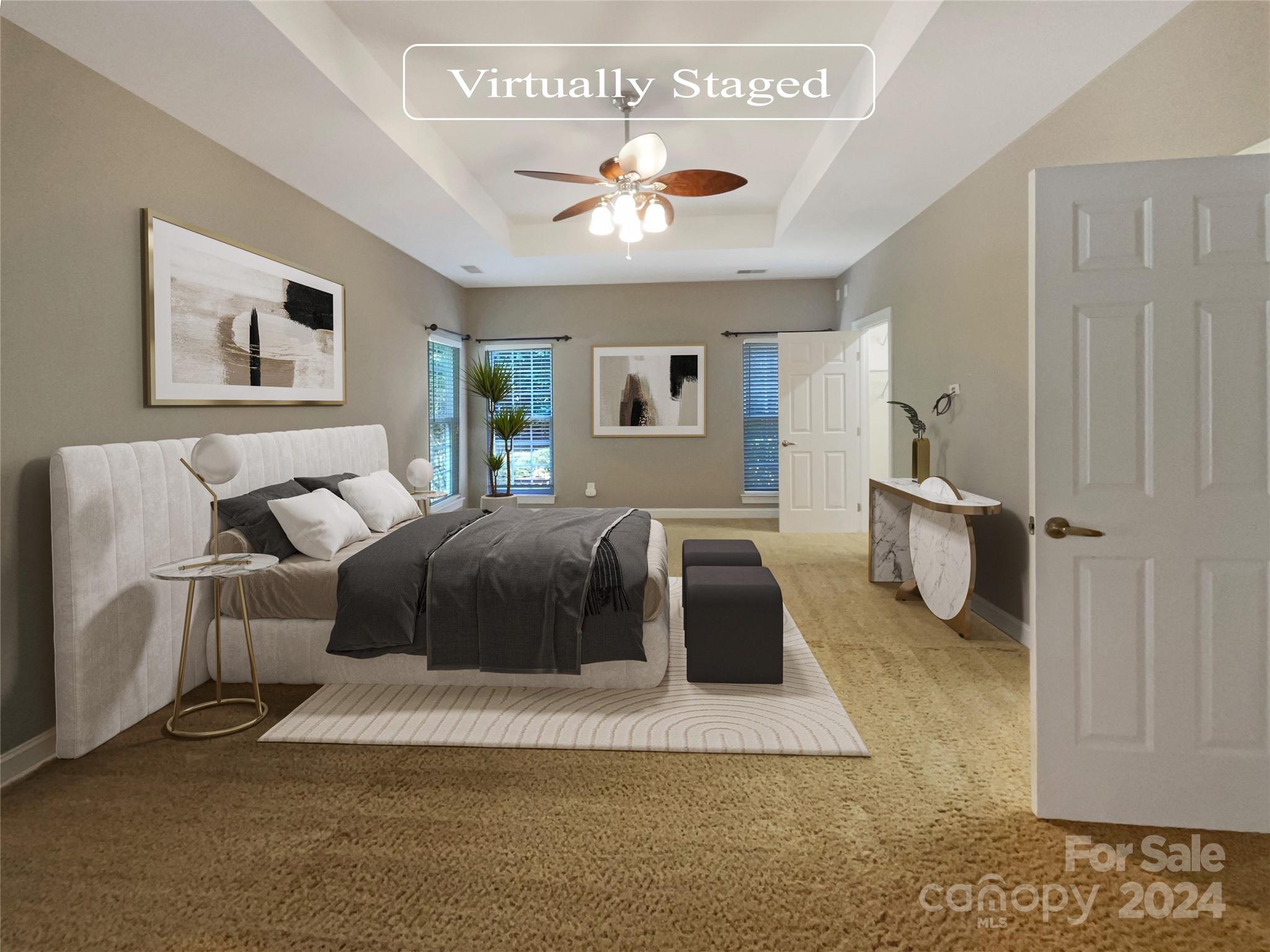 604 Panthers Way Fort Mill, SC 29708 - Photo 4 of 24 a spacious bedroom with a large bed and a chandelier