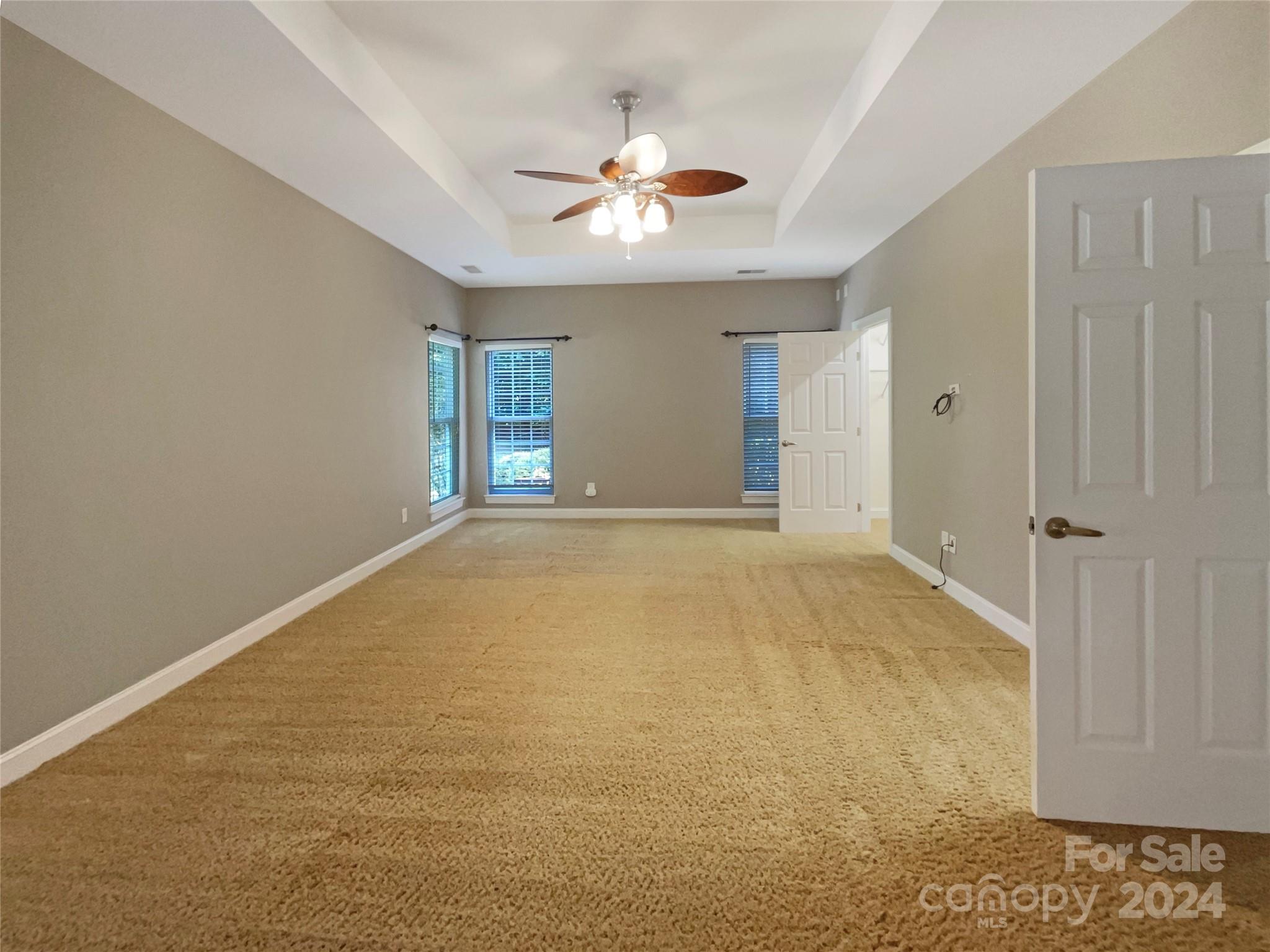 604 Panthers Way Fort Mill, SC 29708 - Photo 5 of 24 an empty room with windows and ceiling fan