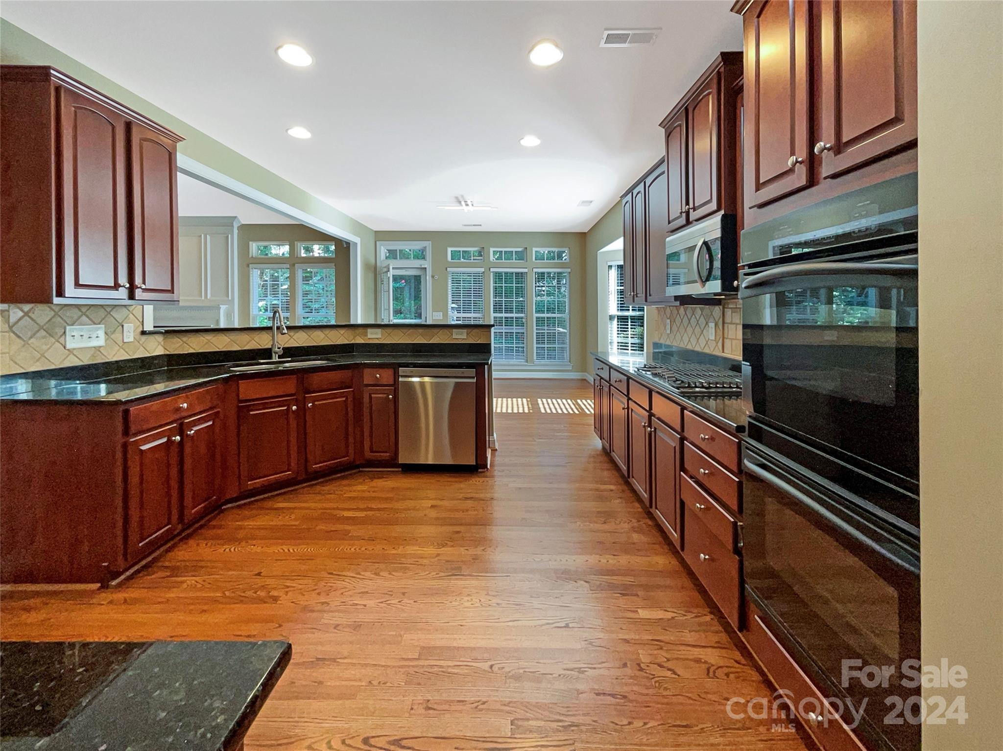 604 Panthers Way Fort Mill, SC 29708 - Photo 6 of 24 a kitchen with stainless steel appliances granite countertop a sink and cabinets