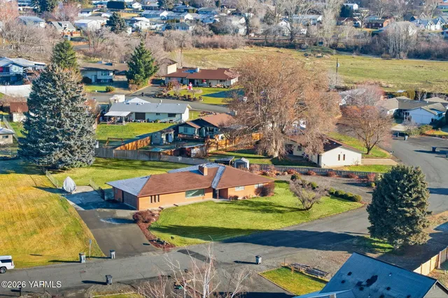 an aerial view of residential houses with outdoor space and seating