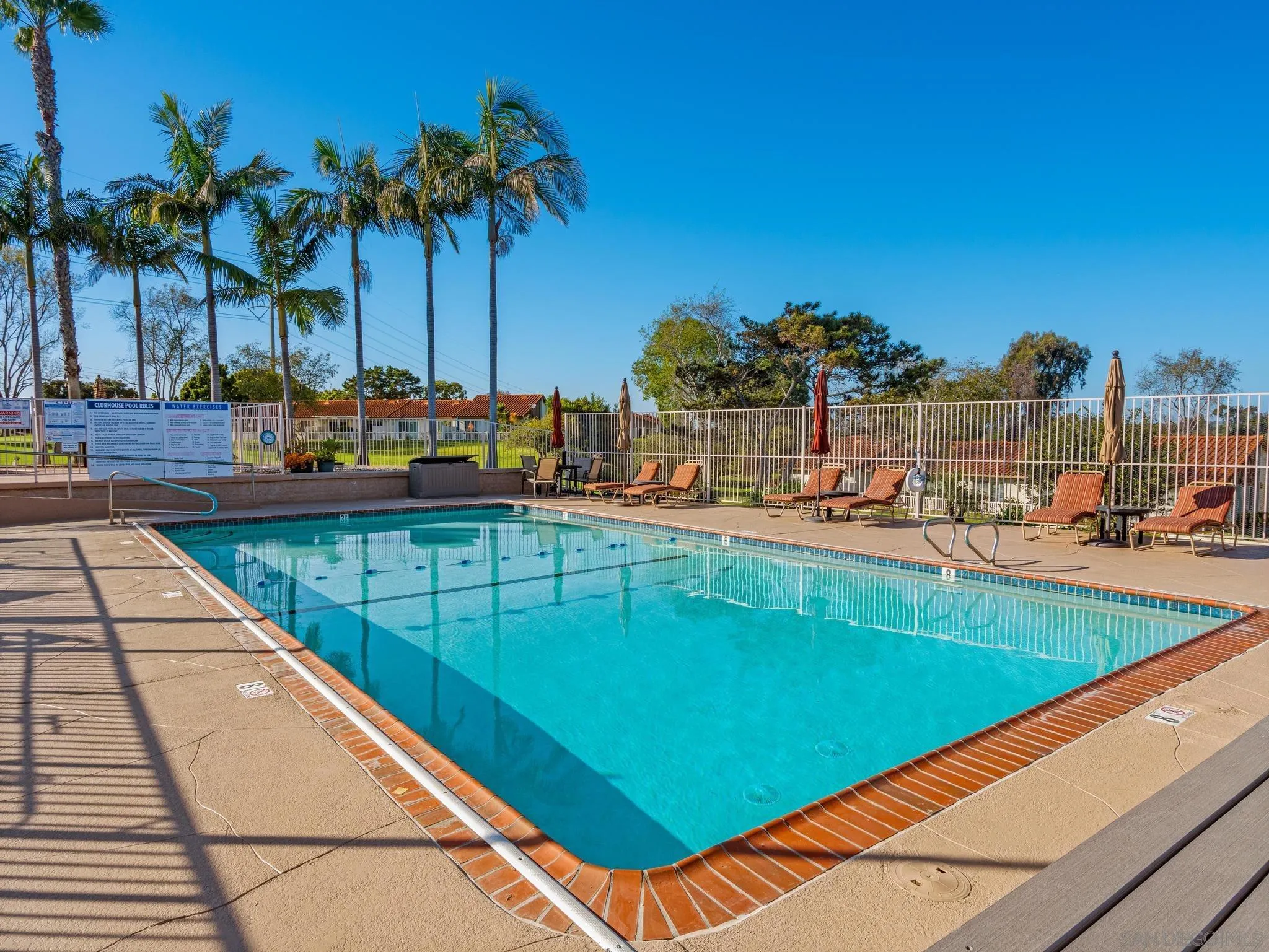 1822 Stanton Road Encinitas, CA 92024 - Photo 16 of 21 a view of a swimming pool with a lawn chairs under an umbrella