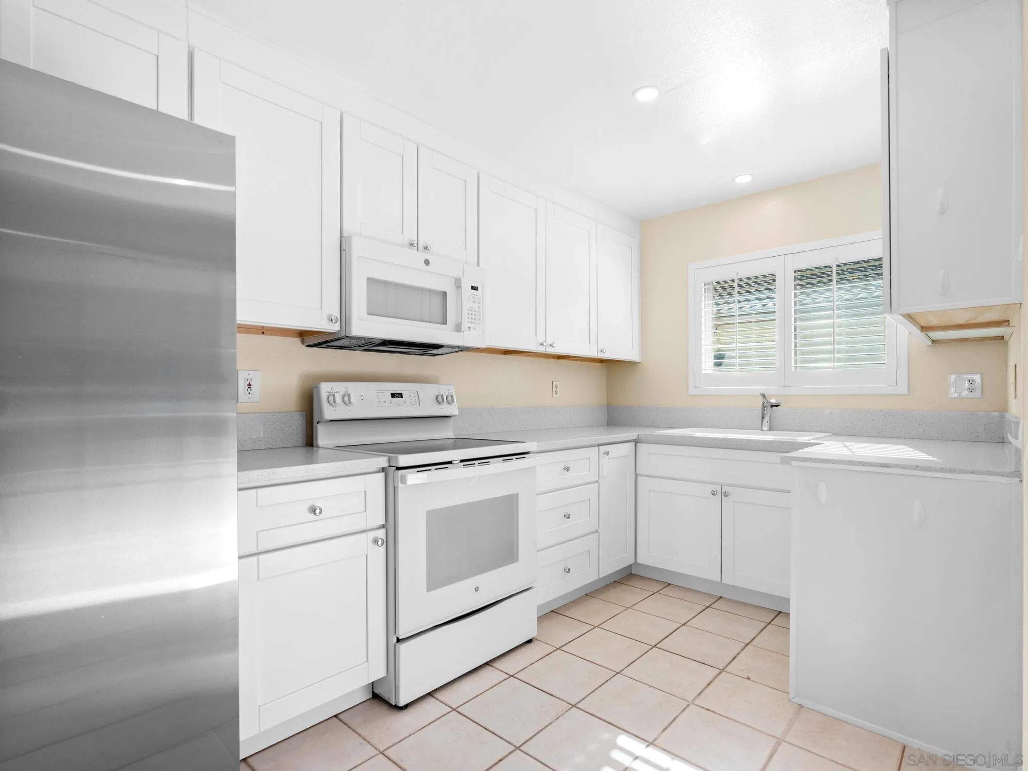 1822 Stanton Road Encinitas, CA 92024 - Photo 2 of 21 a kitchen with cabinets appliances a sink and a window
