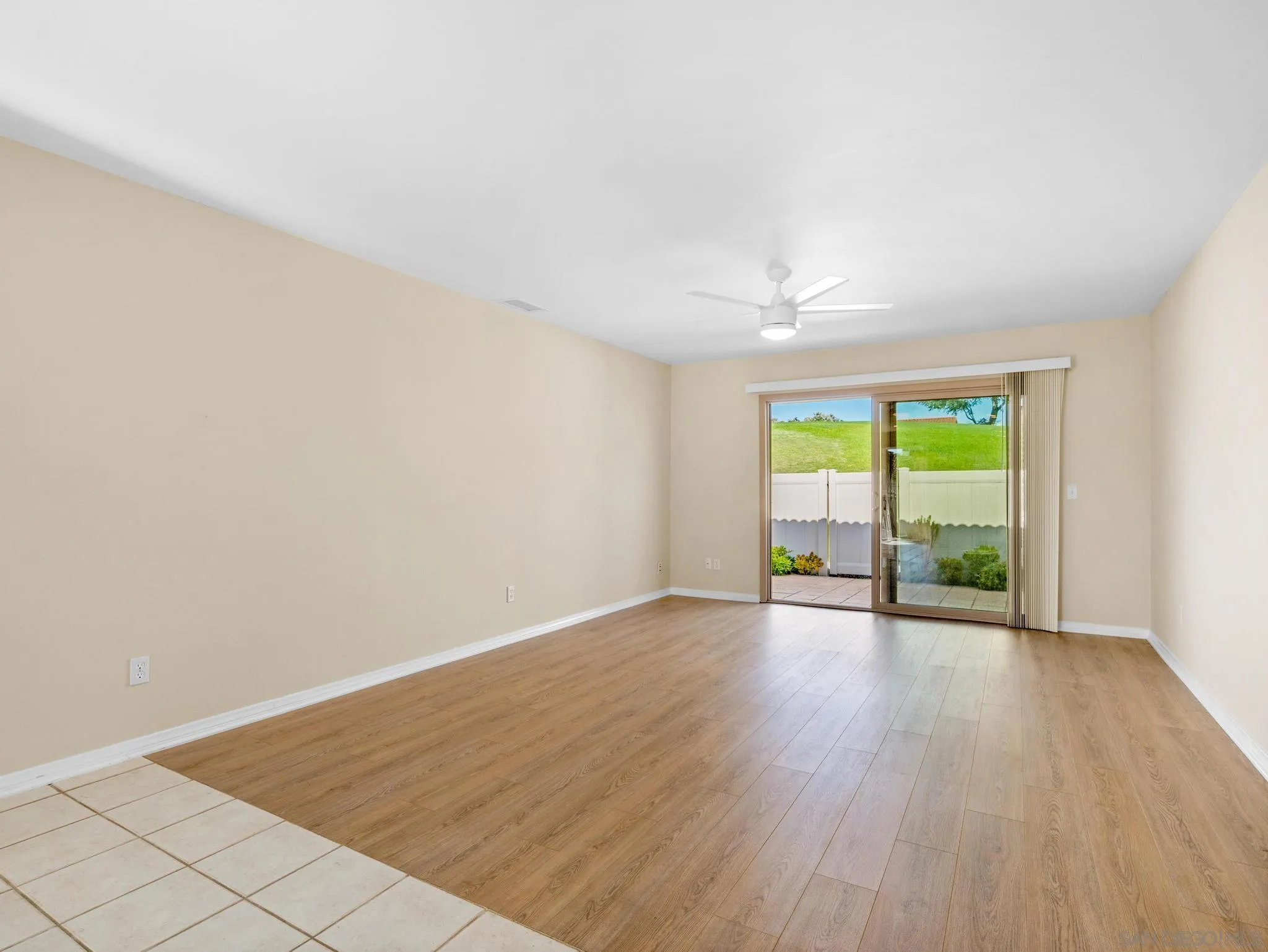 1822 Stanton Road Encinitas, CA 92024 - Photo 4 of 21 an empty room with wooden floor and windows