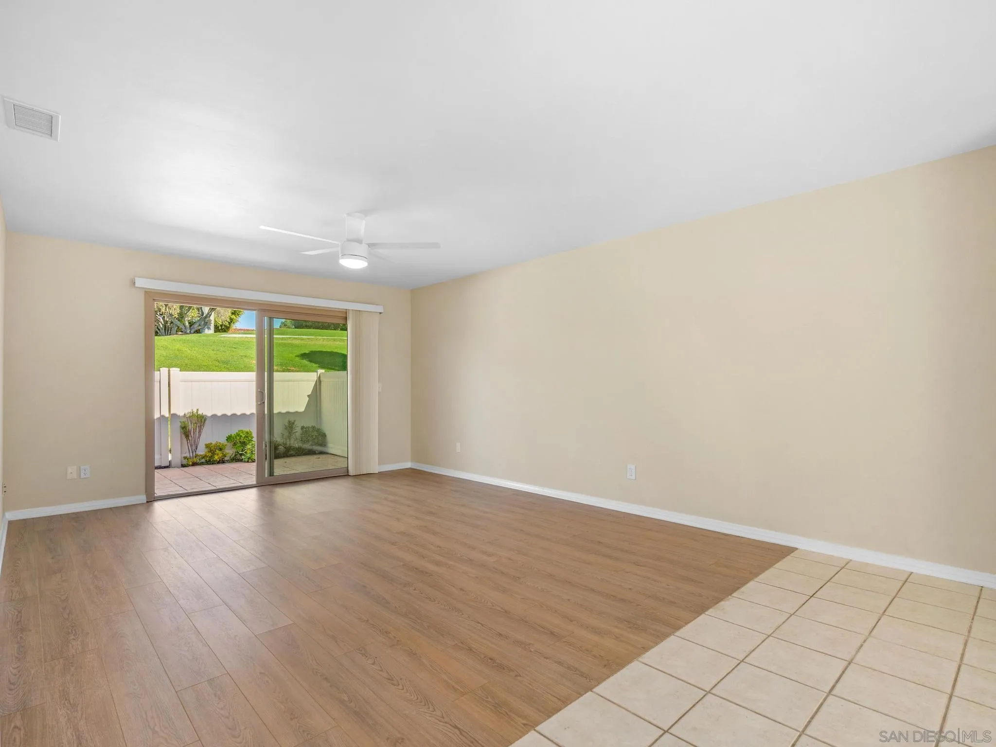 1822 Stanton Road Encinitas, CA 92024 - Photo 6 of 21 an empty room with wooden floor and windows