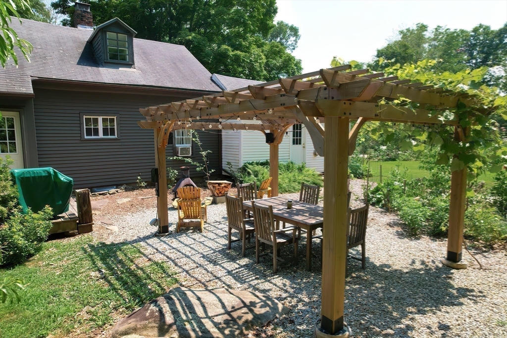 366 Breakneck Road Southbridge, MA 01550 - Photo 18 of 33 a view of a patio with table and chairs under an umbrella with large trees