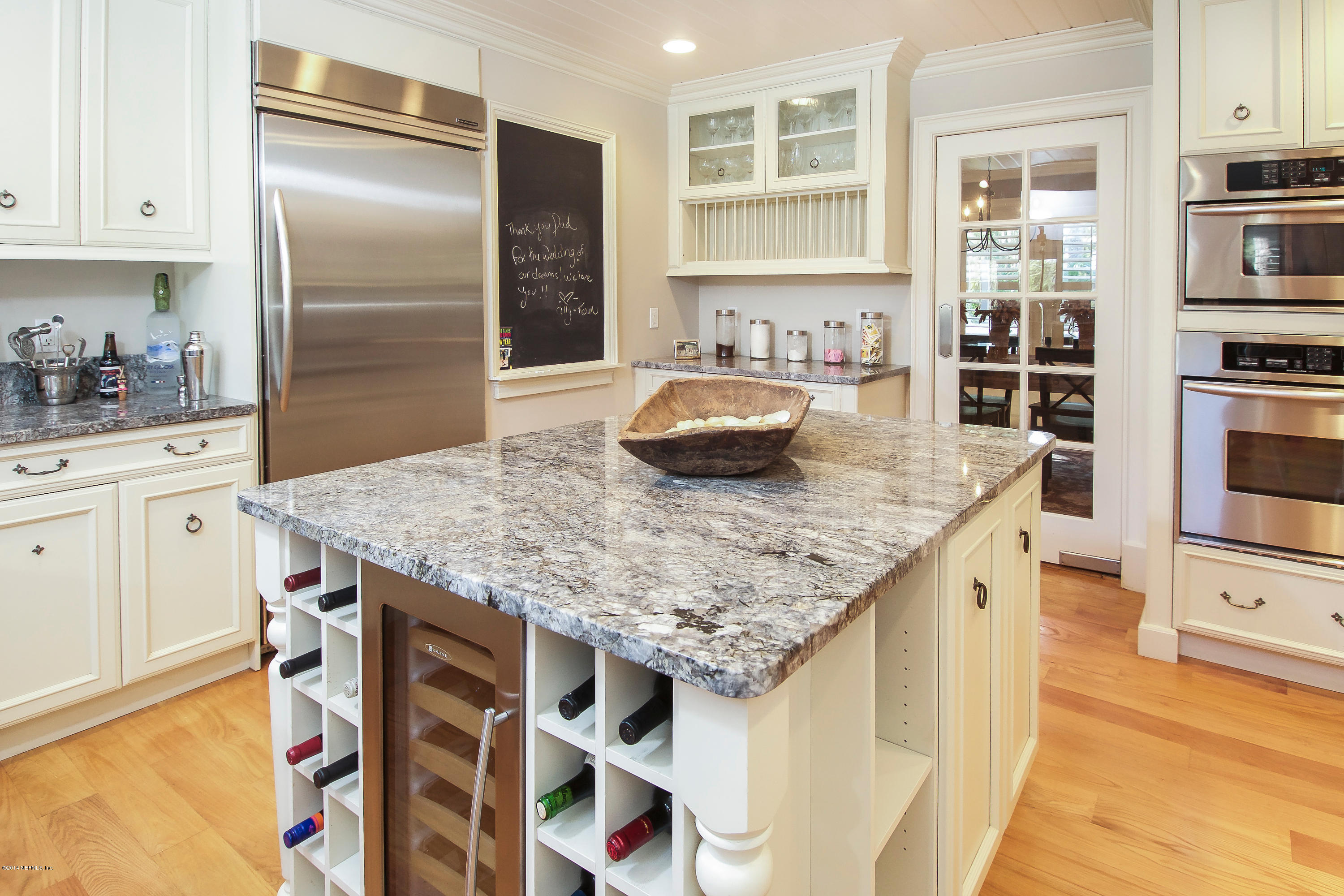 1122 Neck Road Ponte Vedra Beach, FL 32082 - Photo 11 of 35 a kitchen with kitchen island granite countertop a wooden cabinets and refrigerator