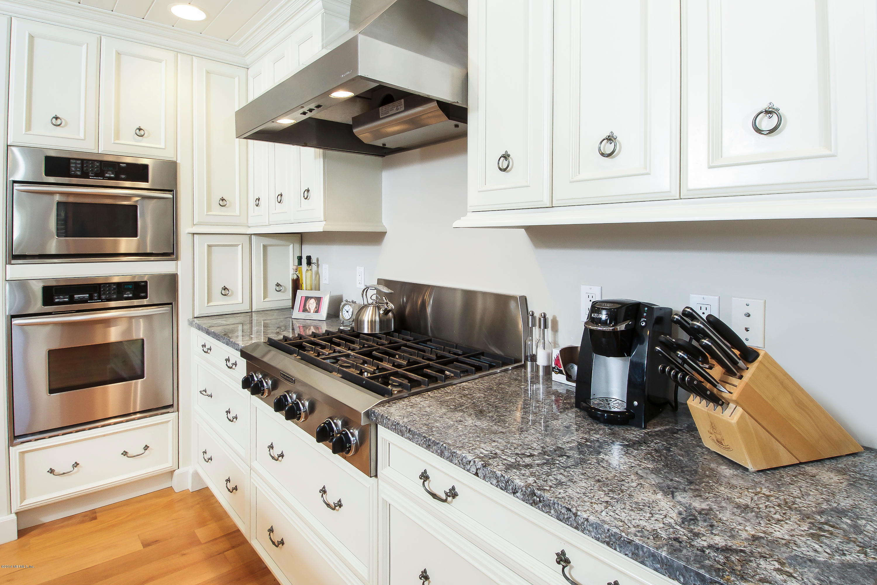 1122 Neck Road Ponte Vedra Beach, FL 32082 - Photo 12 of 35 a kitchen with stainless steel appliances granite countertop white cabinets and a stove a oven with white countertops