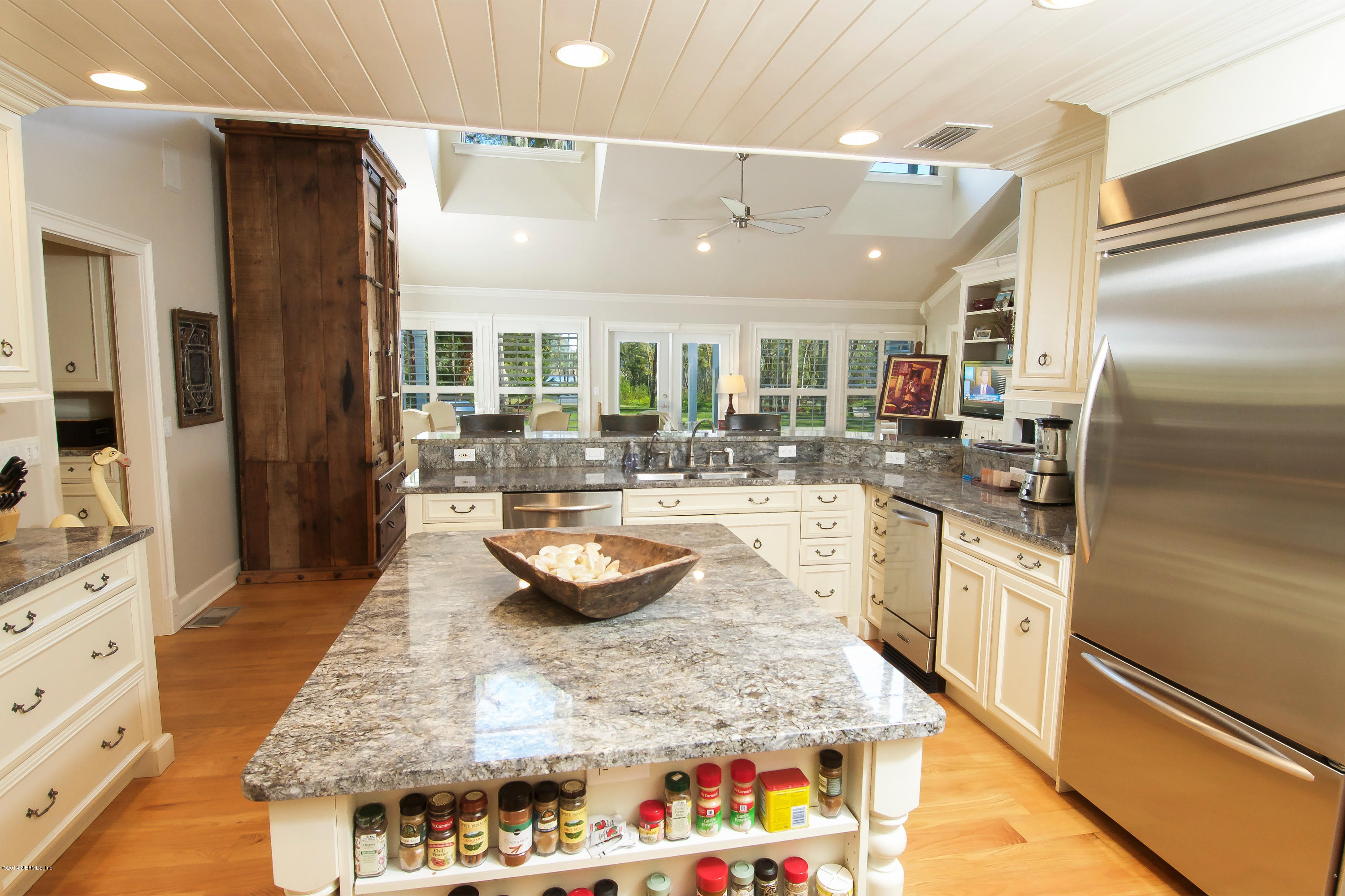 1122 Neck Road Ponte Vedra Beach, FL 32082 - Photo 13 of 35 a large kitchen with kitchen island granite countertop a large counter top stainless steel appliances and cabinets