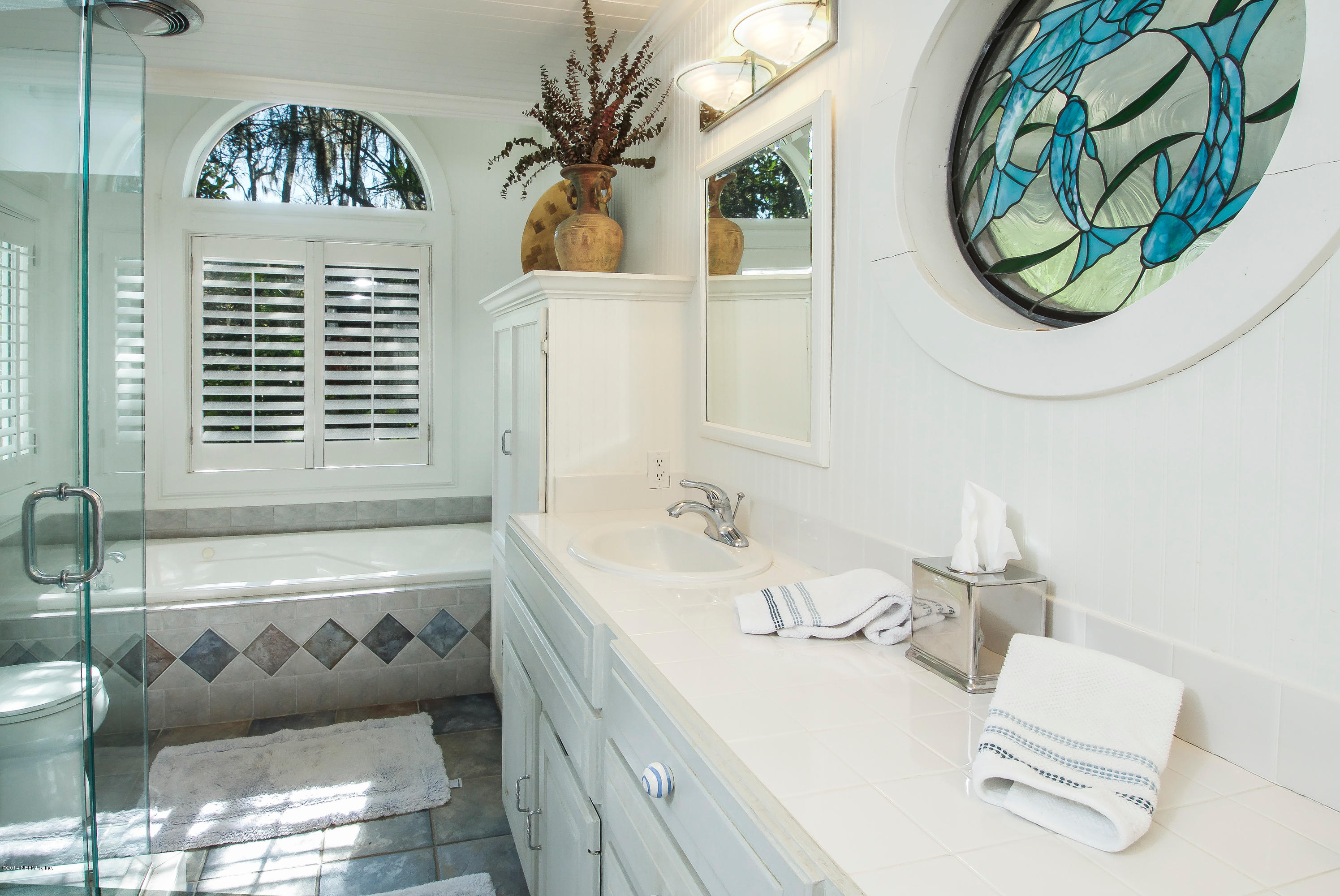 1122 Neck Road Ponte Vedra Beach, FL 32082 - Photo 16 of 35 a bathroom with a bathtub and a window