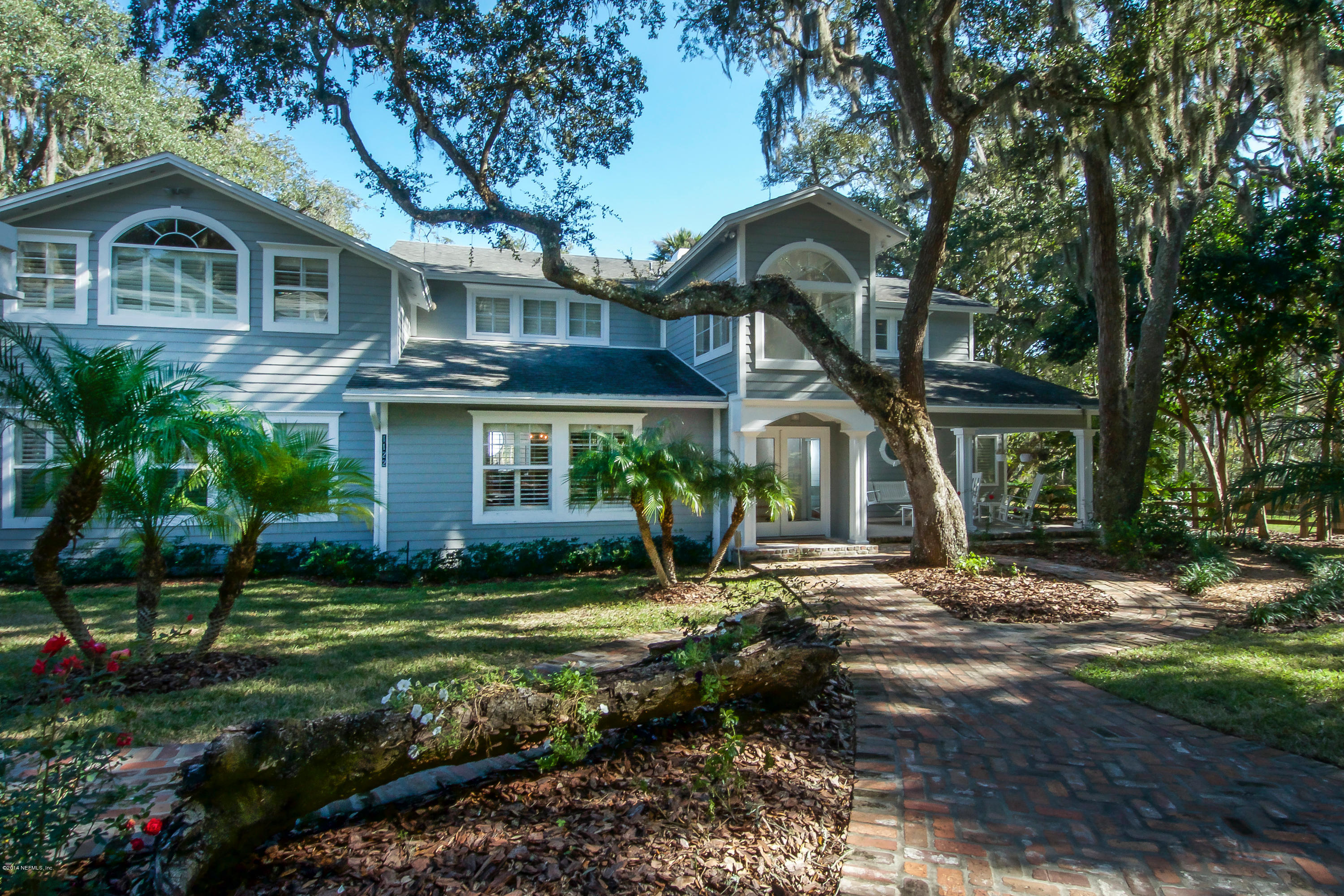 1122 Neck Road Ponte Vedra Beach, FL 32082 - Photo 2 of 35 a front view of a house with a garden