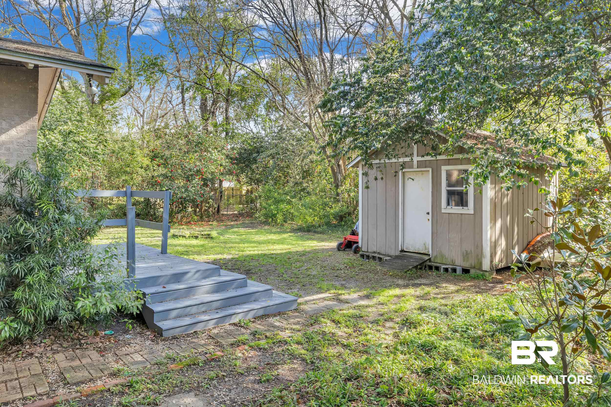 55 Mohawk Street Mobile, AL 36606 - Photo 15 of 28 View of yard with a deck, an outdoor structure, and a shed