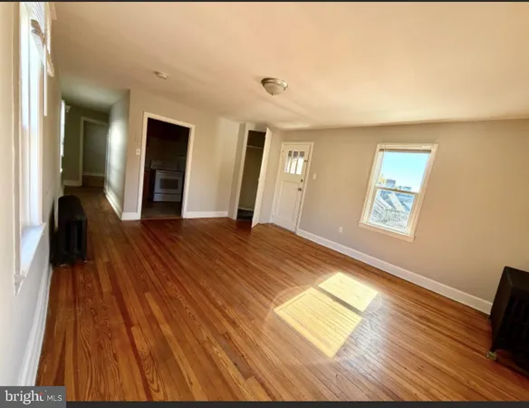 a view of a room with wooden floor and staircase