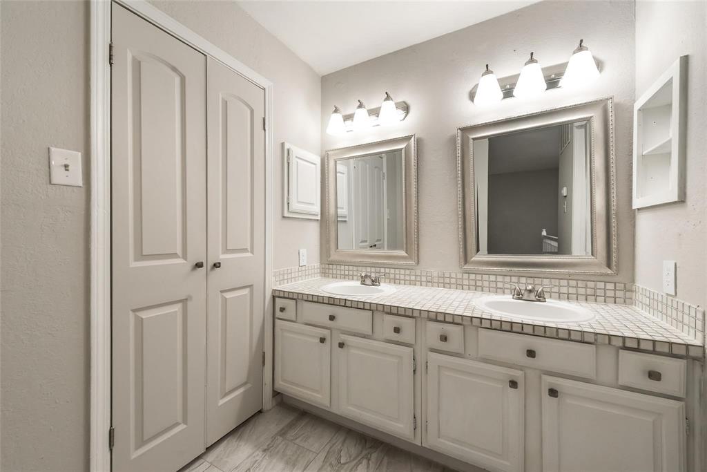 18240 Midway Road, Unit 302 Dallas, TX 75287 - Photo 22 of 33 a bathroom with a double vanity sink and mirror