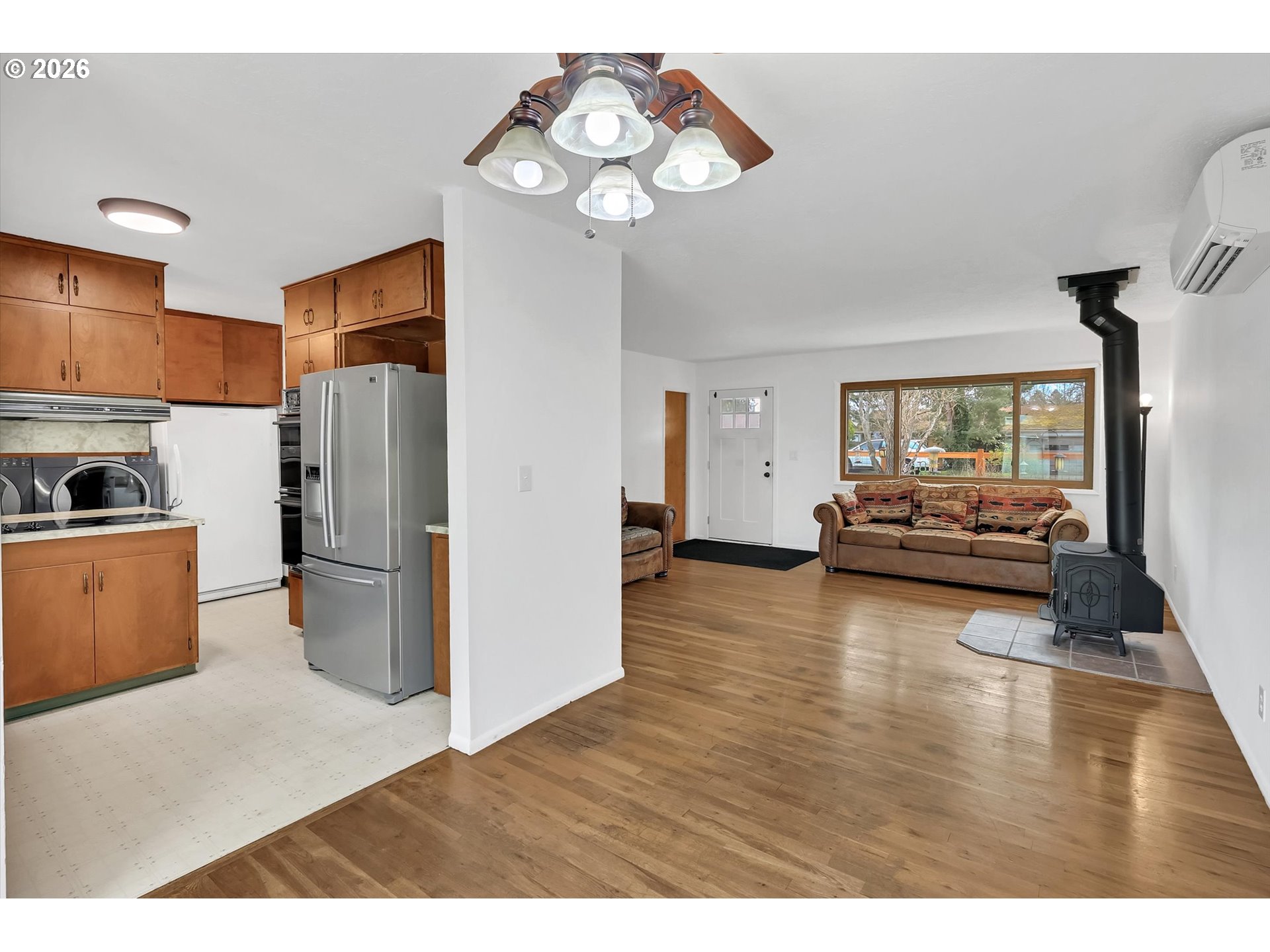515 Harrison Street Fairview, OR 97024 - Photo 12 of 38 a living room with furniture wooden floor and a view of kitchen
