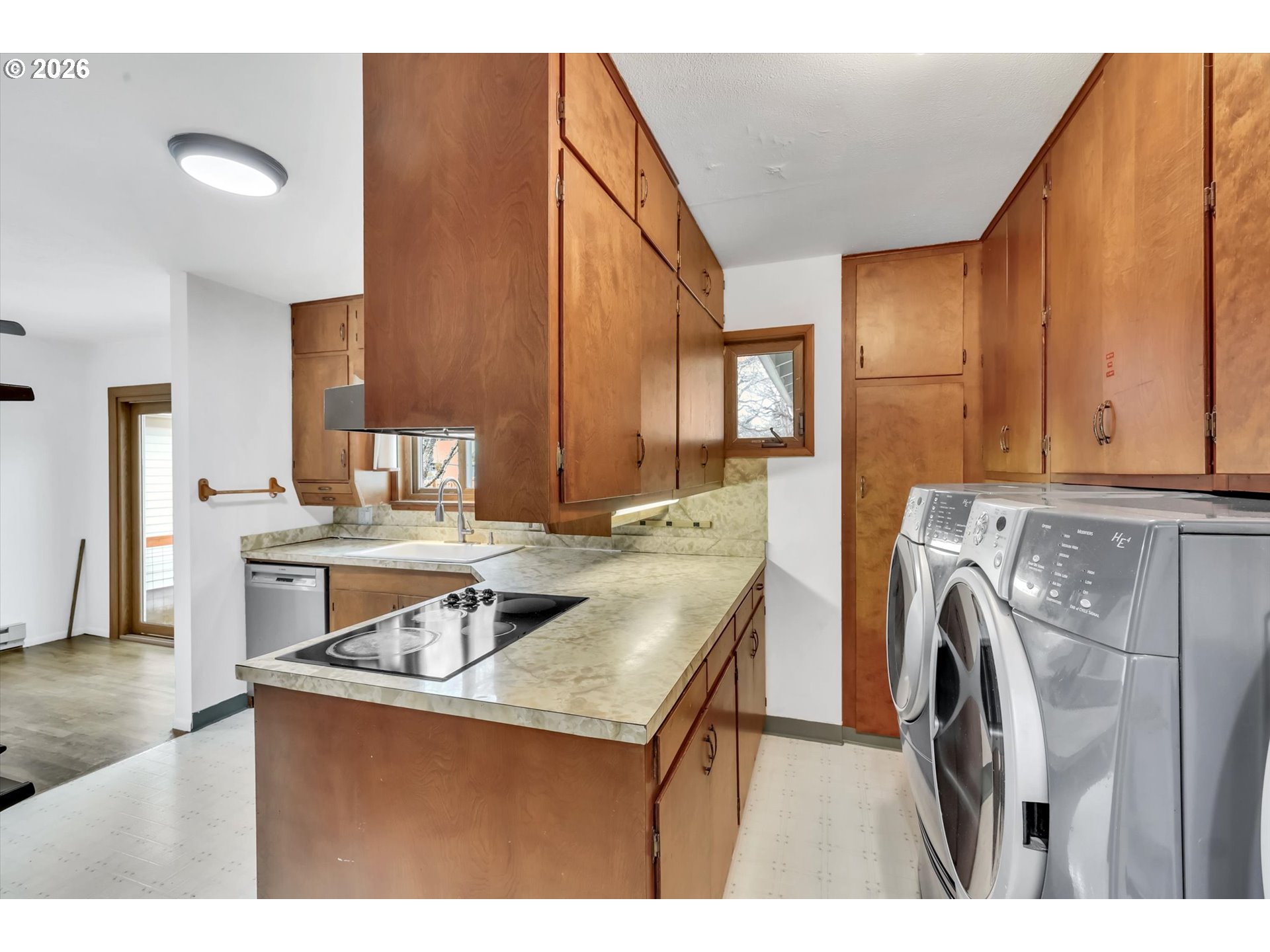 515 Harrison Street Fairview, OR 97024 - Photo 17 of 38 a kitchen with kitchen island a stove a sink and a refrigerator with wooden floor