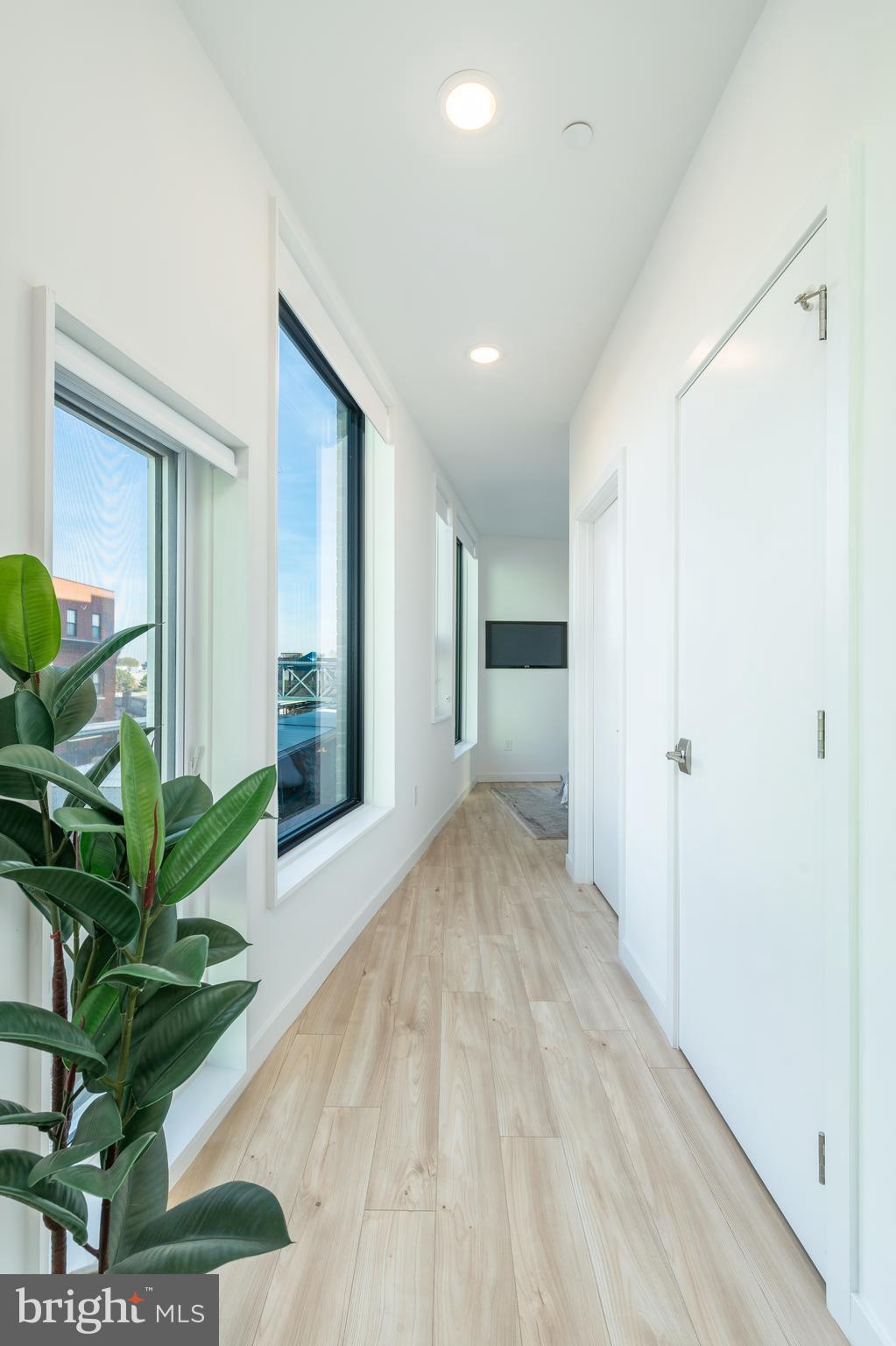 1131-39 North Front Street, Unit 503 Philadelphia, PA 19123 - Photo 22 of 44 a view of a hallway with wooden floor and a living room