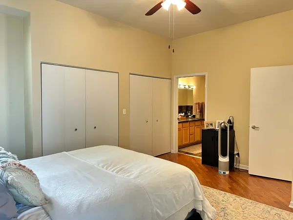 a bedroom with a bed and a chandelier