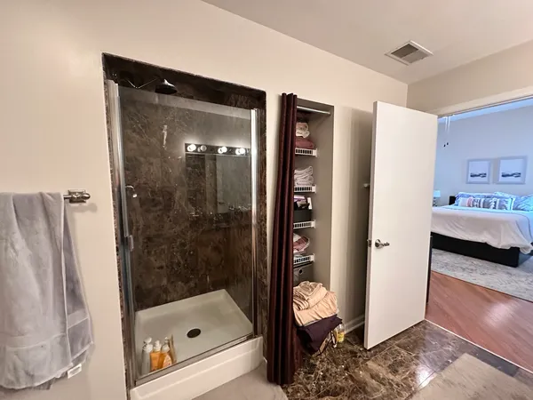a bathroom with a shower and a sink
