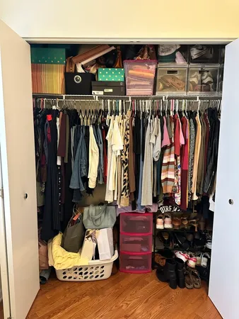 a view of walk in closet with clothes and shoes