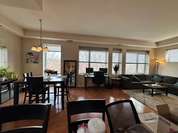 a living room with furniture dining table and a window