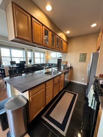 a kitchen with stainless steel appliances granite countertop a stove a sink and a microwave