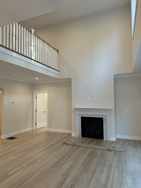 36 Meghan Circle Raynham, MA 02767 - Photo 11 of 37 an empty room with wooden floor windows and fireplace