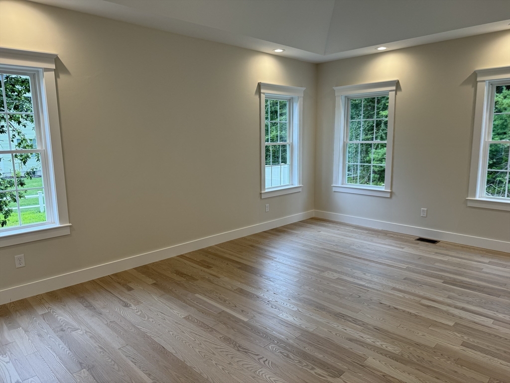 36 Meghan Circle Raynham, MA 02767 - Photo 15 of 37 an empty room with wooden floor and windows