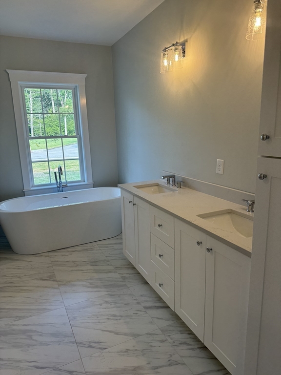 36 Meghan Circle Raynham, MA 02767 - Photo 16 of 37 a bathroom with a tub sink and mirror