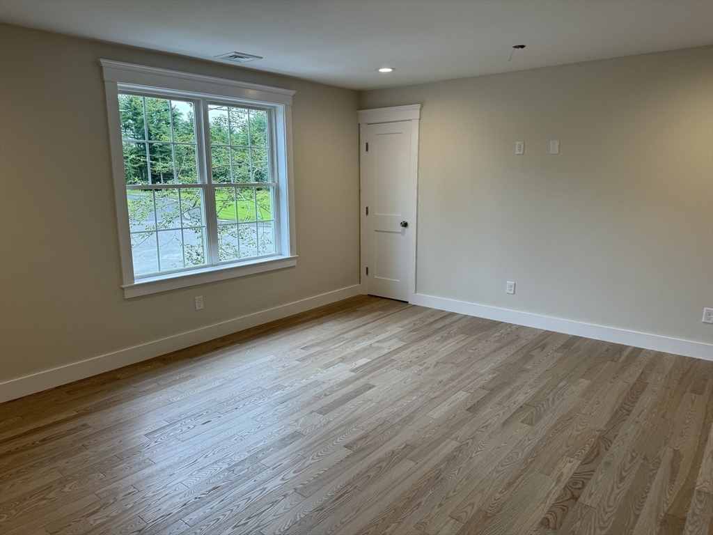 36 Meghan Circle Raynham, MA 02767 - Photo 25 of 37 an empty room with wooden floor and windows