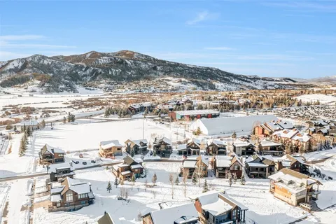 an aerial view of a building with streets and trees