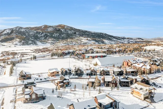 an aerial view of a building with streets and trees