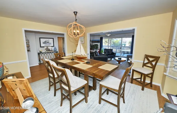 a view of a dining room with furniture wooden floor and chandelier